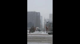 Heavy snowfall begins covering streets and buildings, Minneapolis, USA