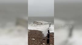 Bananas wash up on a beach as shipping containers topple overboard from cargo ship