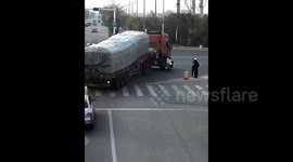 Biker almost crushed in truck's blind spot saved by quick-thinking police officer