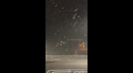 Steady Snowfall Illuminated by Parking Lot Lights in Bluefield