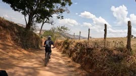 Two Cyclists Wipeout Going Around Curve