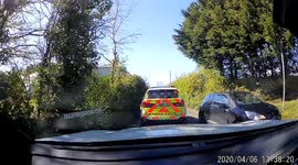 Caught on UK dashcam. Husband driving car winds up his wife who is the passenger and says he is going to overtake the police car driving in front of them on a sunny country road. Wife gets very annoyed and shouts and swears at husband not to overtake. Thi