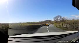 Part 2 of 2 caught on UK dashcam car. Follows directly on from Part 1 where husband pretends he is going to overtake police car driving in front of him. Wife is passenger and is heard to shout and swear at her husband telling him not to overtake.