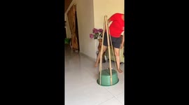 Family use bamboo and green tinsel to create DIY Christmas tree