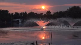 Experienced an amazing sunset across a tranquil lake, which had a beautifully illuminated water fountain, by the sunrays.