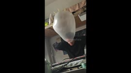 Man turns plastic glove into balloon in Liaoning, China