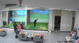 Golfer hits the ceiling of indoor simulator causing sprinkler to burst open