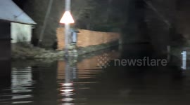 Flooding engulfs roads and laps against outbuildings in the village of Weare Giffard, North Devon, following intense rainfall from Storm Bram.