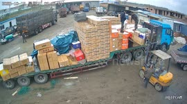 Unloading worker carelessly tosses goods knocking forklift driver to ground