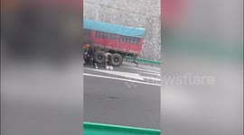 China: Heroic motorist bravely crawls beneath burning truck to tackle blaze on highway