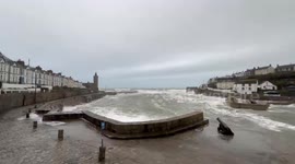 Rough seas and crashing waves hit Porthleven harbour, in Cornwall, England, UK