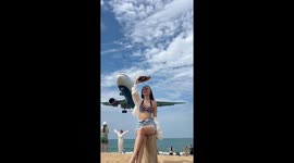 Tourist posing for pictures as plane lands stunned by sound of engine