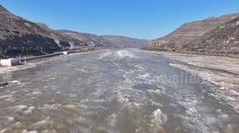 China: Flowing ice, icicles create winter landscape at Hukou Waterfall