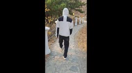 Man walks with shaky legs after climbing the Great Wall in Hebei, China