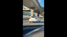 Phone Left Precariously on Moving Vehicle