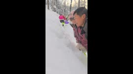 Couple playfully pins each other into deep snow in Jilin, China