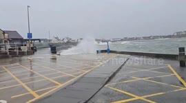 Powerful Atlantic waves crash over breakwater in Trearddur Bay, UK