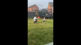 Adorable father-son hose chase in Grimsby, England, UK