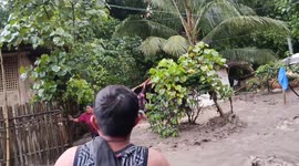 Residents battle through muddy torrents surging through homes