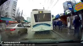 Woman in white ends up covered in mud as bus pulls away and drags her down street