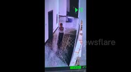 Distracted young boy walking backwards trips and falls into water tank