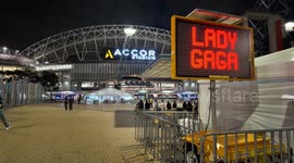 People listen to Lady Gaga concert from outside the stadium in Sydney, Australia