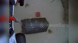 US: Coast Guard Aircrew Hoists Two From Flooded Roof In Sumas
