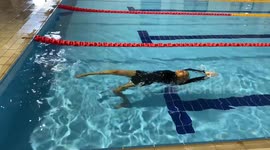Woman Gives Backstroke Her All