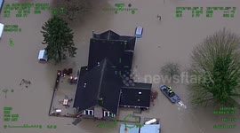 US: Rising Waters Swallow Duvall Home As Marine Deputies Fight To Reach Trapped Family