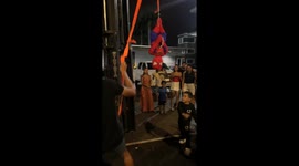 Boy chases piñata holder at birthday party in Puerto Cabello, Venezuela