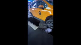 Taxi falls through service vault grate in Times Square, New York, USA