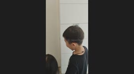 Two Kids Amazed by Digital Lock Washroom in Retail Store