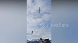 Helicopter flies artificial snow onto ski slope to save season as row erupts