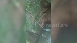 Official executes precision net maneuver, lifting cobra from well in dramatic rescue scene