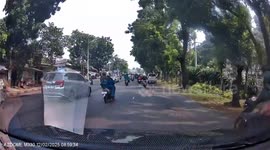 Rider crashes into a motorist while attempting clumsy overtake