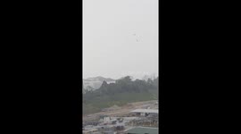 Debris flung through the air as storm hits building site in Singapore
