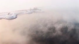 China: Frost smoke cloaks Yellow River after first snowfall in Shandong