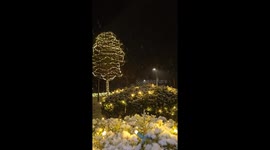 Gentle snowfall enhances holiday-lit campus in Pennsylvania, USA