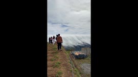 Cloud waterfall tumbles over mountain ridge in the Philippines