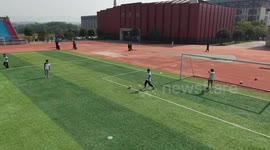 Youngster kicks ball straight at drone camera