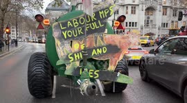 Slogans on Tractors at Parliament Square as Farmers Block Roads in Protest Against Inheritance Tax Reforms, London