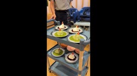 Jelly puddings with party hats wobble while being served to customers