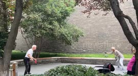 Elderly couple keeps ping-pong rally going without a table
