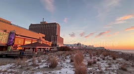 US: Snow Dusted Sunrise Lights Up Atlantic City Beach After Winter Storm