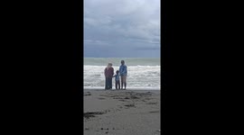 Wave Crashes on Family Trying to Take Aesthetic Video