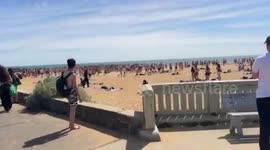 Riot police break up mass brawl among teenagers on beach in Florida