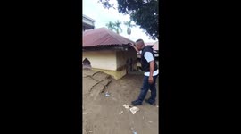 Residents return to homes caked in mud by days of flash floods in Indonesia