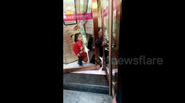 Young girl faints after getting head stuck in Chinese mall's emergency exit door
