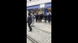 drunk man arrested by armed police in Piccadilly Gardens Manchester for smashing up the Halifax bank