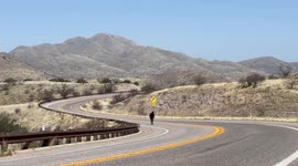 Professional skateboarder (Chad Caruso) pushing up a mountain while skateboarding across America alone